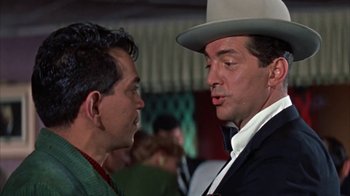 Movie still from “Pepe” (1960), directed by George Sidney – A man wearing a white hat and a black suit; Close Up shot, Over the shoulder angle