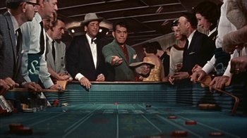 Movie still from “Pepe” (1960), directed by George Sidney – A group of men standing next to each other in a room; Medium shot, High angle