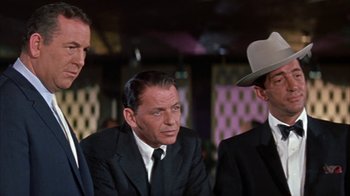 Movie still from “Pepe” (1960), directed by George Sidney – A group of men sitting next to each other in a room; Medium shot, Low angle
