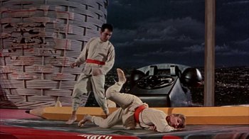 Movie still from “Pepe” (1960), directed by George Sidney – Two men are practicing martial arts on a platform; Wide shot, Low angle