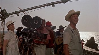 Movie still from “Pepe” (1960), directed by George Sidney – A group of men standing next to each other on a field; Medium shot, Low angle