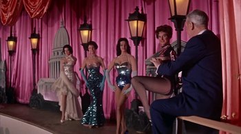 Movie still from “Pepe” (1960), directed by George Sidney – A group of women standing in front of a pink curtain; Wide shot, Low angle