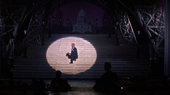 Movie still from “Pepe” (1960), directed by George Sidney – A man standing in front of a building on a stage; Extreme Wide shot, Low angle