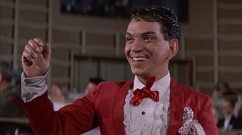 Movie still from “Pepe” (1960), directed by George Sidney – A person wearing a suit and a bow tie; Close Up shot, Low angle