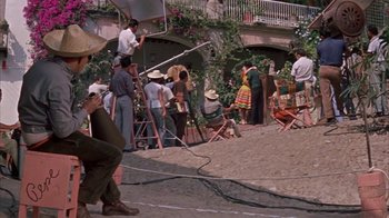 Movie still from “Pepe” (1960), directed by George Sidney – A group of people standing on top of a dirt field; Wide shot, Low angle