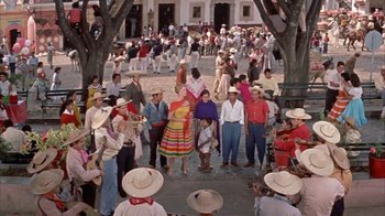 Movie still from “Pepe” (1960), directed by George Sidney – A group of people standing on a street with hats on their heads; Extreme Wide shot, High angle
