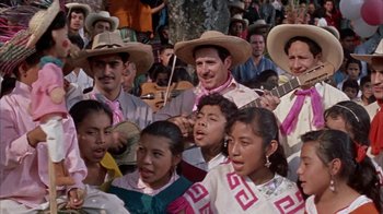 Movie still from “Pepe” (1960), directed by George Sidney – A group of people wearing hats and holding instruments; Medium shot, High angle