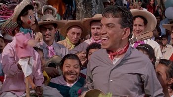 Movie still from “Pepe” (1960), directed by George Sidney – A group of men in hats and ties sitting next to each other; Medium shot, Low angle
