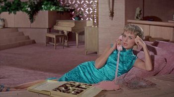 Movie still from “Pepe” (1960), directed by George Sidney – A woman in a blue dress talking on a phone; Medium shot, High angle
