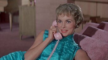 Movie still from “Pepe” (1960), directed by George Sidney – A woman sitting on a couch talking on a phone; Close Up shot, Low angle