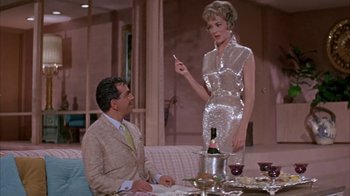 Movie still from “Pepe” (1960), directed by George Sidney – A man and a woman are sitting at a dinner table; Medium shot, Low angle