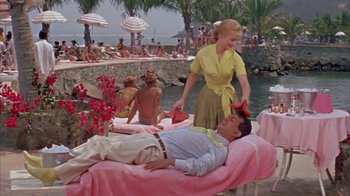 Movie still from “Pepe” (1960), directed by George Sidney – A man and a woman in front of a pool; Wide shot, High angle