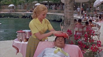 Movie still from “Pepe” (1960), directed by George Sidney – A woman in a yellow shirt and a man in a pink shirt; Medium shot, High angle