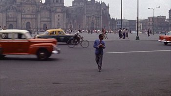 Movie still from “Pepe” (1960), directed by George Sidney – A man walking across the street in a busy city; Wide shot, High angle