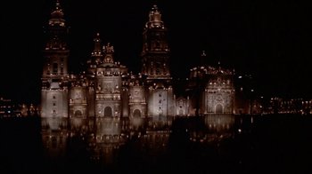 Movie still from “Pepe” (1960), directed by George Sidney – A large building lit up at night with lights; Extreme Wide shot, High angle