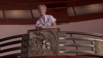 Movie still from “Pepe” (1960), directed by George Sidney – A woman standing on top of a metal sculpture; Medium shot, Low angle