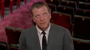 Movie still from “Pepe” (1960), directed by George Sidney – A person wearing a suit and a tie; Close Up shot, Low angle
