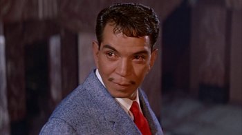 Movie still from “Pepe” (1960), directed by George Sidney – A person wearing a suit and tie; Close Up shot, Low angle