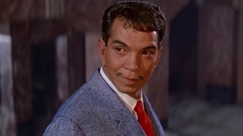 Movie still from “Pepe” (1960), directed by George Sidney – A person wearing a suit and tie; Close Up shot, Low angle
