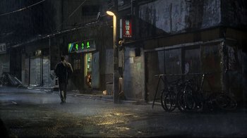 A man walking down the street in the rain