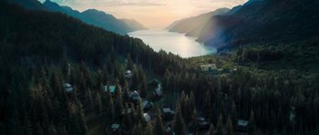 An aerial view of a lake and a forest