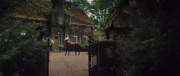 Movie still from “Percy Jackson: Sea of Monsters” (2013), directed by Thor Freudenthal – A person riding on the back of a brown horse; Wide shot, Low angle