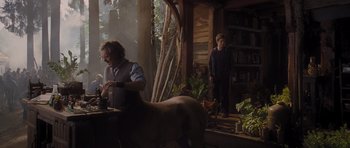 Movie still from “Percy Jackson: Sea of Monsters” (2013), directed by Thor Freudenthal – A man and a woman standing next to each other in a room; Wide shot, Over the shoulder angle