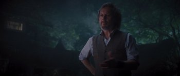 Movie still from “Percy Jackson: Sea of Monsters” (2013), directed by Thor Freudenthal – A man standing in front of a forest at night; Medium shot, Over the shoulder angle