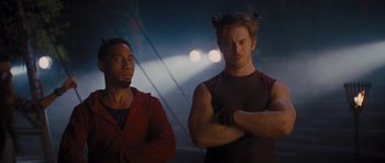 Movie still from “Percy Jackson: Sea of Monsters” (2013), directed by Thor Freudenthal – Two men standing next to each other in front of lights; Medium shot, Low angle