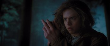 Movie still from “Percy Jackson: Sea of Monsters” (2013), directed by Thor Freudenthal – A man with a messy hair style holding a cell phone; Close Up shot, Low angle