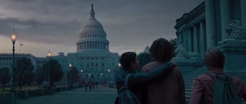Movie still from “Percy Jackson: Sea of Monsters” (2013), directed by Thor Freudenthal – Two people hug in front of the capitol building; Medium shot, Low angle