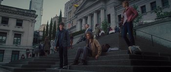 Movie still from “Percy Jackson: Sea of Monsters” (2013), directed by Thor Freudenthal – Two young men sitting on the steps in front of a building; Wide shot, Low angle