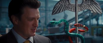 Movie still from “Percy Jackson: Sea of Monsters” (2013), directed by Thor Freudenthal – A man in a business suit looking at a snake; Close Up shot, Over the shoulder angle