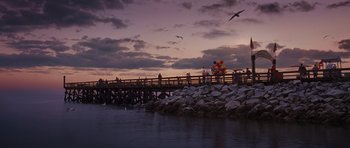 Movie still from “Percy Jackson: Sea of Monsters” (2013), directed by Thor Freudenthal – A group of people standing on a pier near a body of water; Extreme Wide shot, High angle