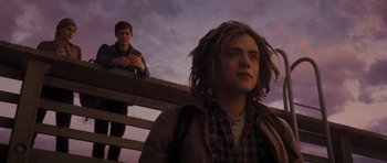 Movie still from “Percy Jackson: Sea of Monsters” (2013), directed by Thor Freudenthal – Two young people are sitting on a wooden bench; Medium shot, Low angle