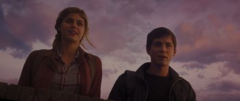 Movie still from “Percy Jackson: Sea of Monsters” (2013), directed by Thor Freudenthal – A man and a woman standing next to each other in front of a cloudy sky; Medium shot, Low angle