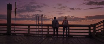 Movie still from “Percy Jackson: Sea of Monsters” (2013), directed by Thor Freudenthal – Two people standing on a pier looking out at the water; Wide shot, Low angle