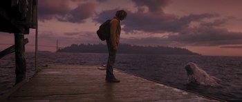 Movie still from “Percy Jackson: Sea of Monsters” (2013), directed by Thor Freudenthal – A man standing on a pier looking out at the water; Wide shot, Low angle