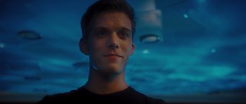 Movie still from “Percy Jackson: Sea of Monsters” (2013), directed by Thor Freudenthal – A young man in a black t - shirt looks into the camera; Close Up shot, Low angle