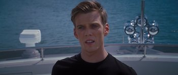 Movie still from “Percy Jackson: Sea of Monsters” (2013), directed by Thor Freudenthal – A young man in a black t - shirt looks at the camera; Close Up shot, Over the shoulder angle