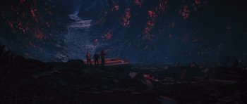 Movie still from “Percy Jackson: Sea of Monsters” (2013), directed by Thor Freudenthal – Three people standing in a cave with a boat in the background; Extreme Wide shot, High angle