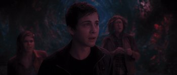 Movie still from “Percy Jackson: Sea of Monsters” (2013), directed by Thor Freudenthal – A young man standing in front of another man; Medium shot, Over the shoulder angle