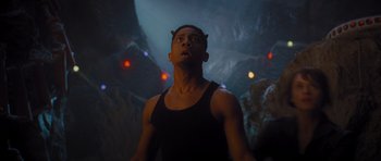 Movie still from “Percy Jackson: Sea of Monsters” (2013), directed by Thor Freudenthal – A man in a black tank top looking up at the sky; Medium shot, Low angle