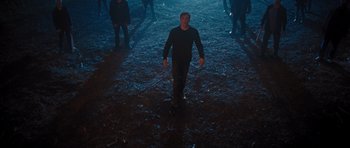 Movie still from “Percy Jackson: Sea of Monsters” (2013), directed by Thor Freudenthal – A man is walking in the dark with a group of people; Wide shot, High angle