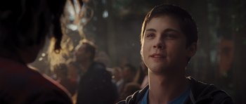 Movie still from “Percy Jackson: Sea of Monsters” (2013), directed by Thor Freudenthal – A young man is looking into the distance while standing in front of a group of people; Close Up shot, Over the shoulder angle