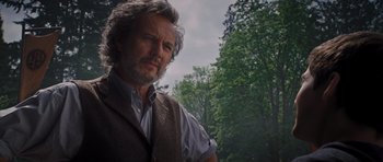 Movie still from “Percy Jackson: Sea of Monsters” (2013), directed by Thor Freudenthal – A person wearing a vest near a forest; Close Up shot, Low angle