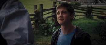 Movie still from “Percy Jackson: Sea of Monsters” (2013), directed by Thor Freudenthal – A young man standing in front of a wooden fence; Close Up shot, Over the shoulder angle