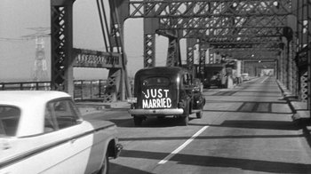 Movie still from “Period of Adjustment” (1962), directed by George Roy Hill – A car that has just married on the side of the road; Wide shot, High angle