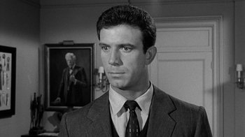 Movie still from “Period of Adjustment” (1962), directed by George Roy Hill – Black and white photograph of a man wearing a suit and tie; Close Up shot, Over the shoulder angle