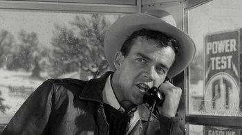 Movie still from “Period of Adjustment” (1962), directed by George Roy Hill – A black and white photo of a man talking on a phone; Close Up shot, Low angle